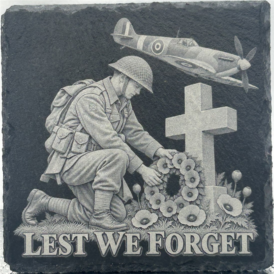 Remembrance design showing a kneeling soldier with a wreath beside a cross